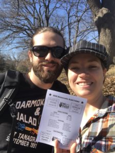 Two people hold voter information literature